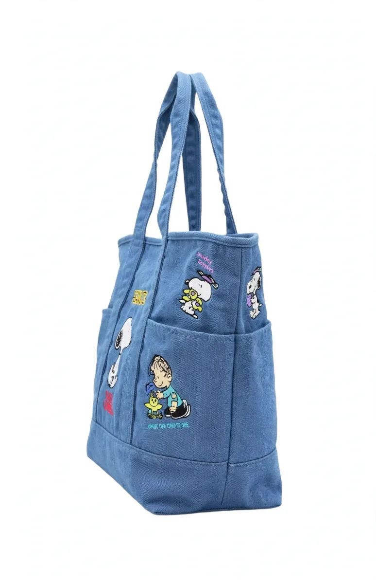 Peanuts Snoopy blue denim tote bag with character pockets featuring Snoopy, Woodstock, Charlie Brown, Linus and Lucy